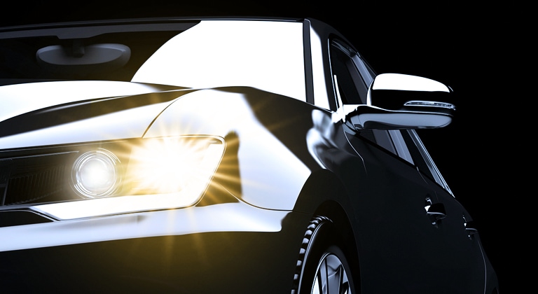 Samsung LEDs a turn signal light illuminating a yellow light on the black squared car