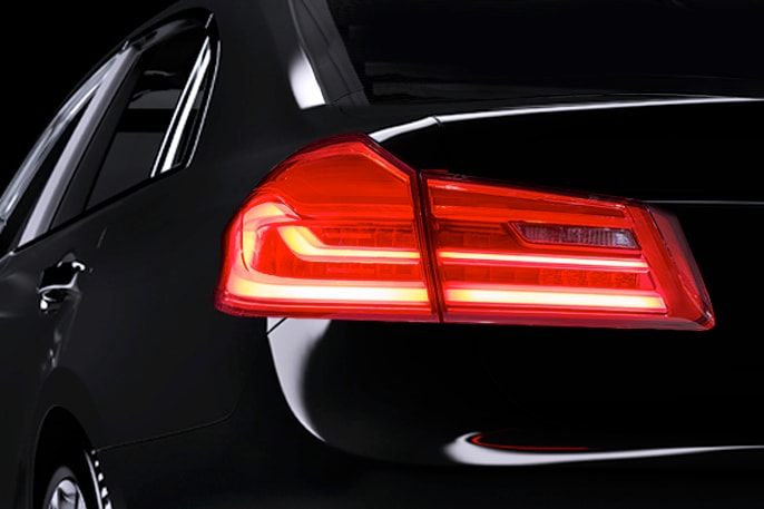 Samsung LEDs a turn signal light illuminating a yellow light on the black squared car