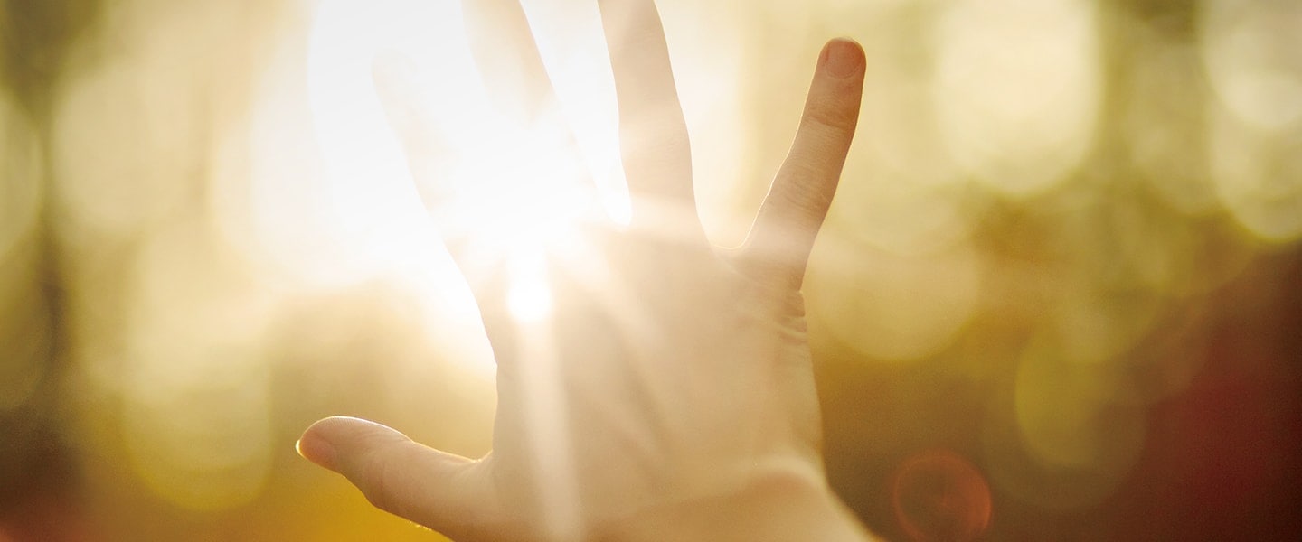  A photo of hand stretched to sunset.