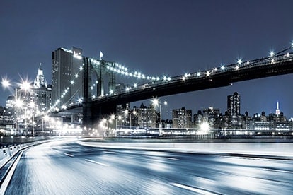  Samsung LEDs an empty high way with white lights shining along it and a suspension bridge lighted up across it